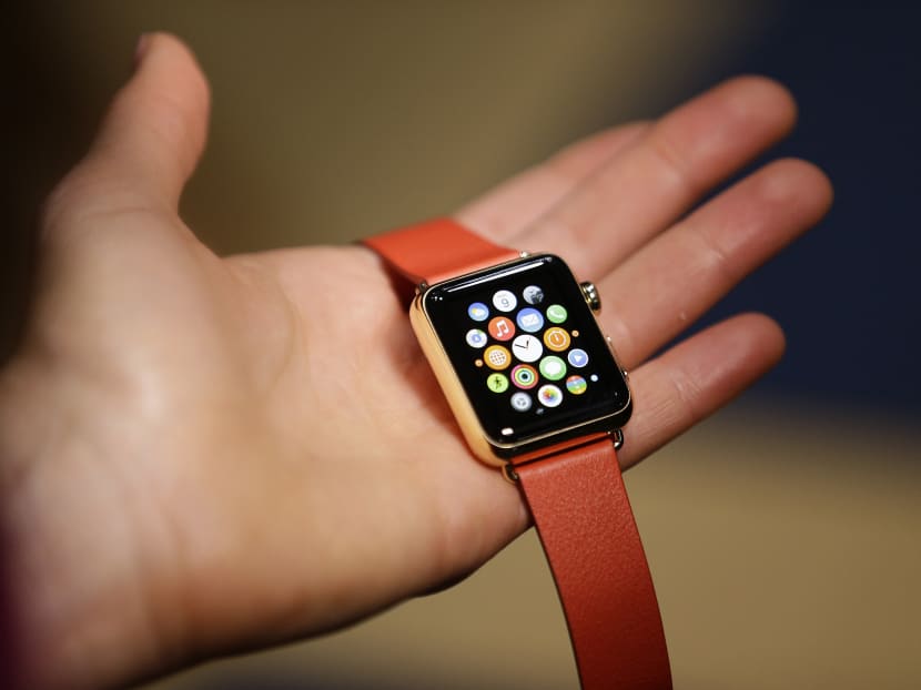 A woman holds the Apple Watch Edition during a demo following an Apple event this morning (March 10, Singapore time). Photo: AP