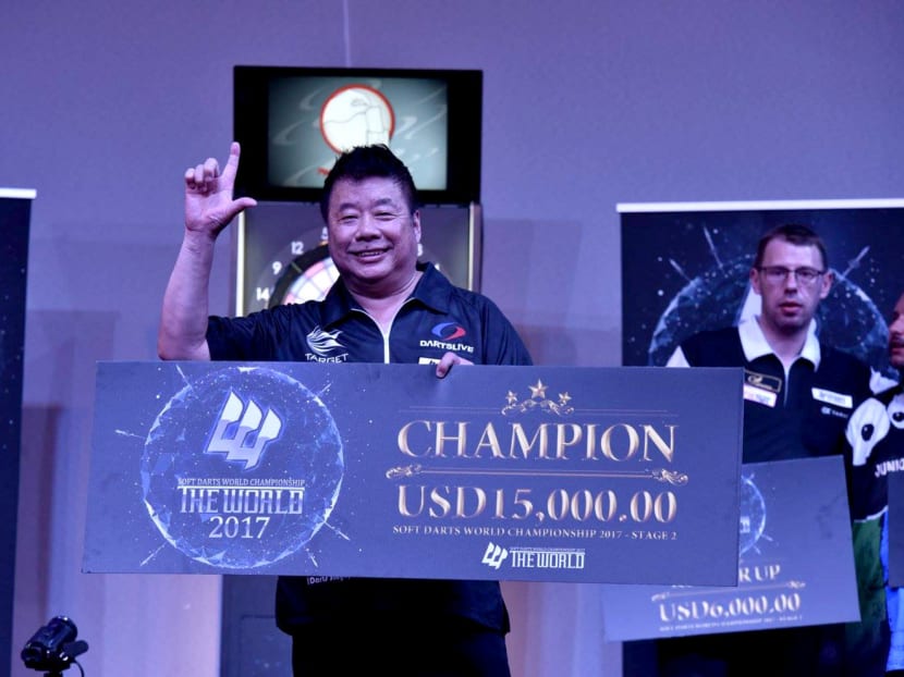 Paul Lim with his winner’s cheque. His latest triumph sees him rise to the top of The World rankings, with four more stages to go. Photo: The World Soft Darts World Championship Facebook page