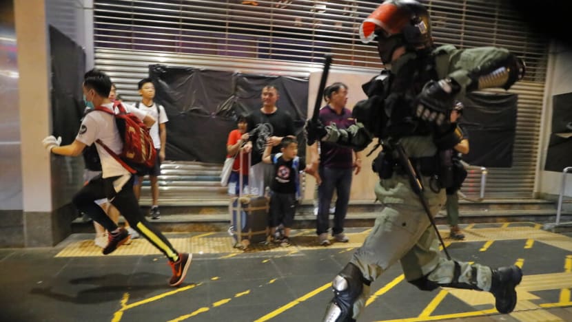 Hong Kong protesters spread out in flash mobs, policeman slashed in the neck