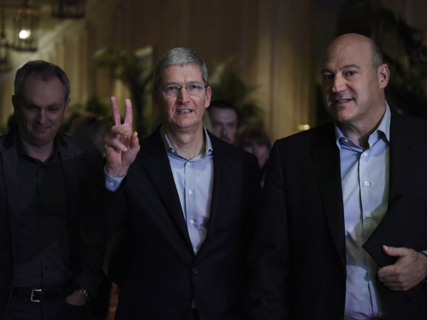 Apple CEO Tim Cook, center, arrives to speak with President and CEO of Goldman Sachs Group, Mr Gary Cohn, right, at the Goldman Sachs Technology And Internet Conference in San Francisco, California, US, last Tuesday (Feb 10). Photo: Bloomberg