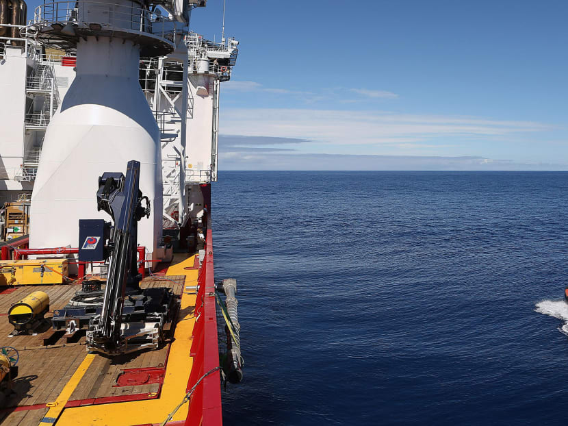 Crew members are seen aboard a fast response craft, right, from the Australian Defence Vessel Ocean Shield, left, as they continue to search for debris of the missing Malaysian Airlines flight MH370 in the southern Indian Ocean, in this picture released by the Australian Defence Force on April 8, 2014.  Photo: Reuters