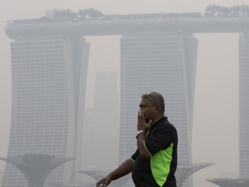 A man covers his nose during a hazy day in Singapore. Photo: AP
