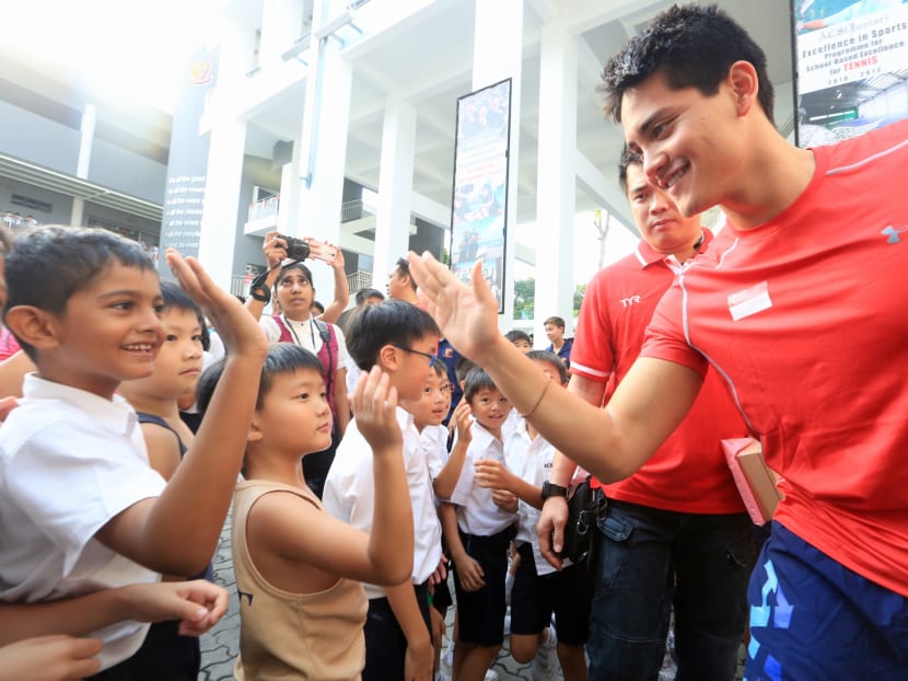 Schooling high-fives students at ACS (Junior). Photo: Koh Mui Fong/TODAY Schooling high-fives students at ACS (Junior). Photo: Koh Mui Fong/TODAY