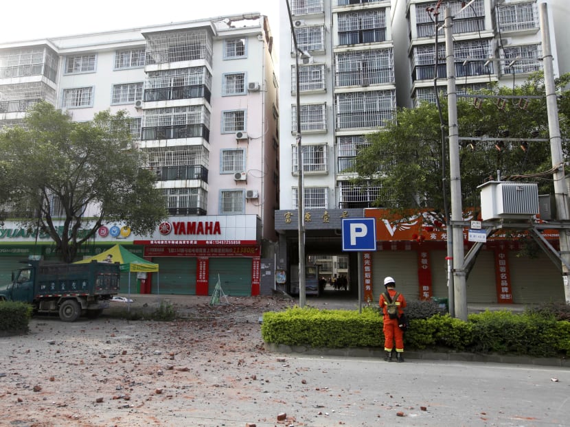 A Chinese firefighter stands at the scene of an explosion in Liucheng county in southern China's Guangxi Zhuang Autonomous Region Thursday, Oct. 1, 2015.  Photo: AP