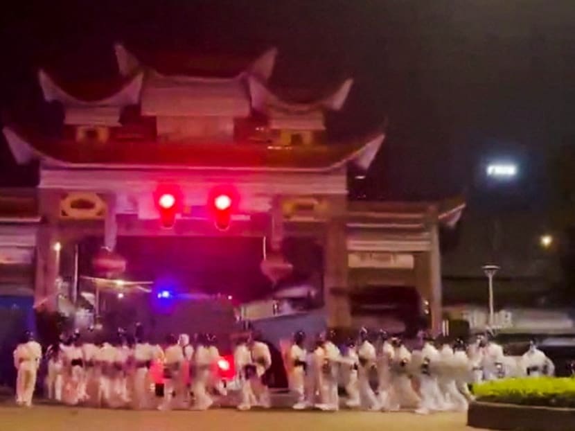 Riot police in personal protection suits arrive during protests over Covid-19 restrictions, in Guangzhou, China in a screen grab taken from a social media video released Nov 29, 2022.