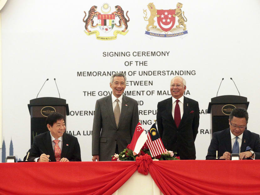Singapore's Prime Minister Lee Hsien Loong and Malaysia's Prime Minister Najib Razak look on as Singapore's Transport Minister Khaw Boon Wan, and Malaysia's Minister in the Prime Minister's department Abdul Rahman Dahlan sign the HSR MOU in Putrajaya on July 19, 2016. TODAY file photo