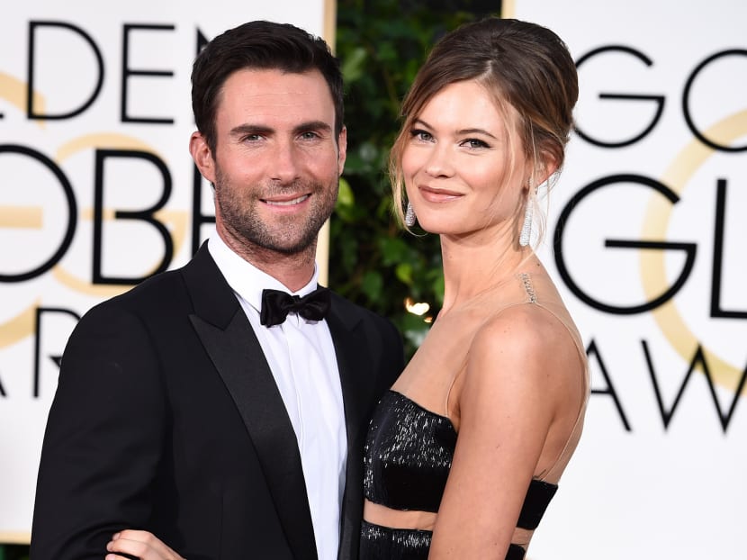 Adam Levine, left, and Behati Prinsloo arrive at the 72nd annual Golden Globe Awards at the Beverly Hilton Hotel on Jan 11, 2015, in Beverly Hills, Calif. Photo: Invision via AP