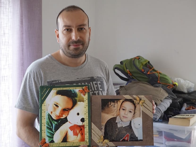 In this photo taken May 11, 2015, Feridun Mustafaoglu  hold pictures of his children  in his small one-room rental during an interview with The Associated Press, in Stavanger, Norway. Photo: AP