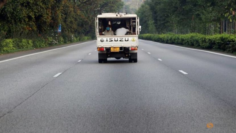file photo migrant workers sit in the back of a lorry amid the coronavirus disease covid 19 outbreak in singapore 5 0
