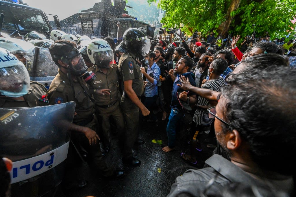 University students speak with police during a demonstration demanding the resignation of Sri Lanka's President Gotabaya Rajapaksa over the country's crippling economic crisis, in Colombo on May 19, 2022.