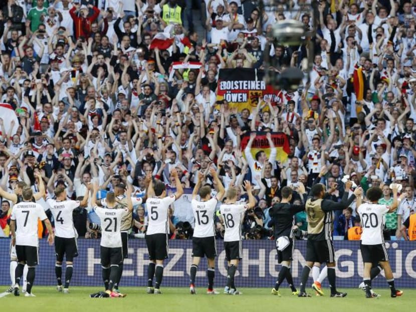 The Germany team saluting their fans after their 3-0 destruction of Slovakia in their Round of 16 clash. Photo: AP