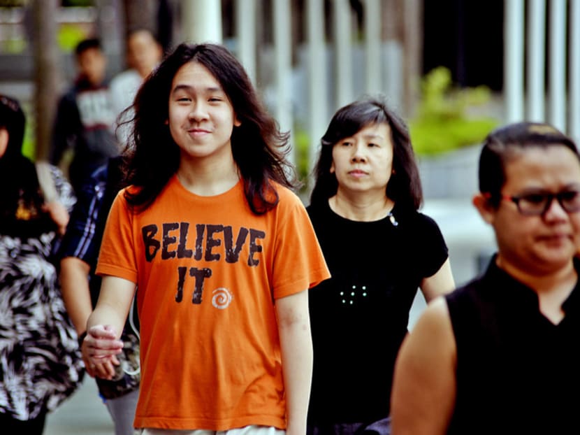 Amos Yee (left) and his mother arriving at the State Court yesterday. He objected to a joint hearing for the two sets of offences he was charged with, but was overruled. PHOTO: Robin Choo