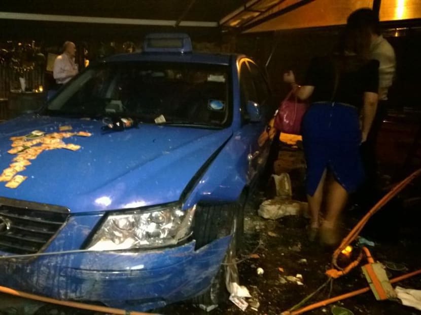 A taxi slammed into the outdoor area of a bar, Georges Mad Bar & Grill, along East Coast Road on April 17, 2014, after it got involved in an accident with another car. Photo: Sunny Naresh