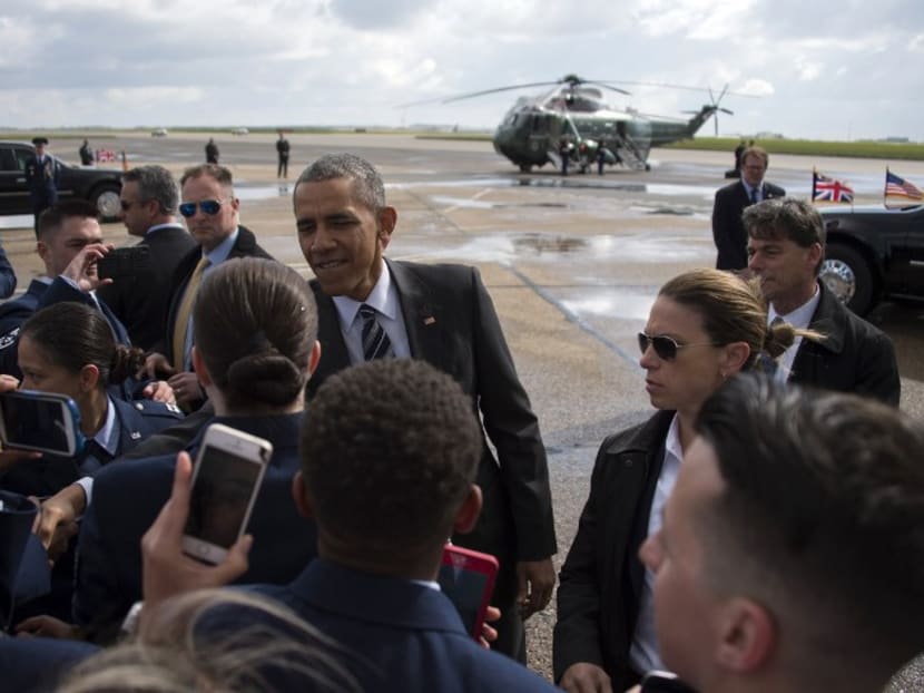 US President Barack Obama shakes hands with members of the US Air Force as he prepares to leave London's Stansted airport on April 24, 2016, on his way to Germany. Photo: AFP