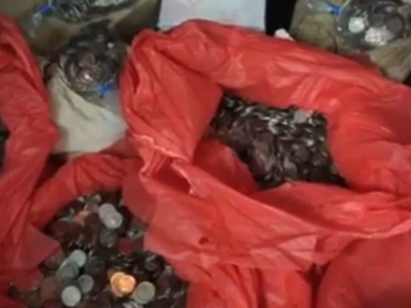 S$19,067.85 in coins left at the car showroom. Photo: Channel NewsAsia