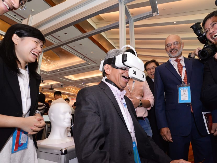 Dr Yaacob Ibrahim (centre), minister for Communications and Information, trying out the Ambiotherm virtual reality headset accessory at the innovfest unbound Singapore 2017, on May 3, 2017. Photo: Robin Choo/TODAY