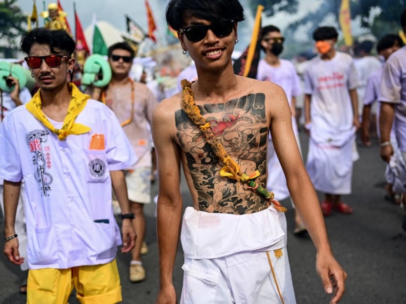 Devotees of the Jor Soo Gong Naka shrine take part in a procession during the annual Vegetarian Festival in Phuket on Sept 27, 2022.