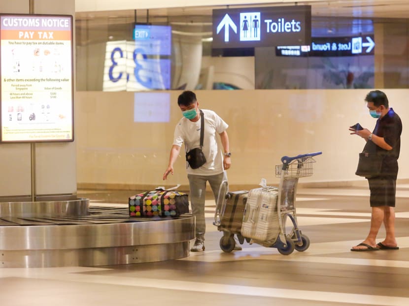 Passengers collecting their baggage at the arrival hall of Changi Airport.