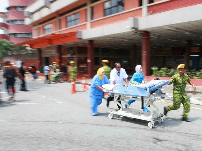 A patient being evacuated from Hospital Sultanah Aminah in Johor Baru yesterday, after smoke was spotted at an operating theatre. Photo: The New Straits Times (Press) Malaysia