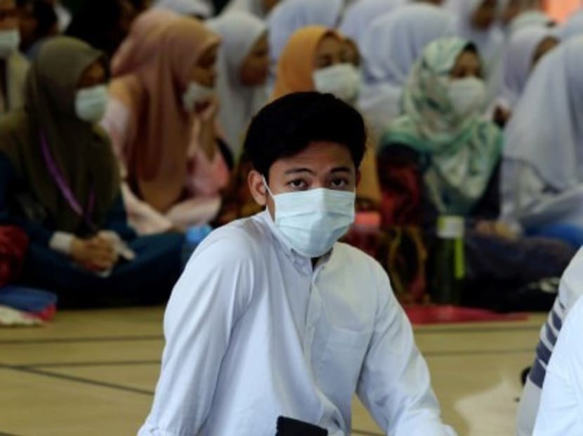 A student at a school in Pasir Gudang wears a face mask as a precautionary measure after the latest pollution incident.