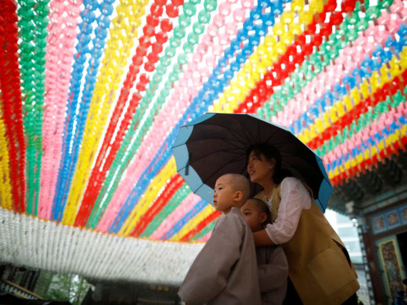 Photo of the day: Novice monks walk underneath lotus lanterns bearing prayer petitions as they leave after an event to celebrate the upcoming Vesak Day, the birthday of Buddha, at Jogye temple in Seoul on Wednesday.
