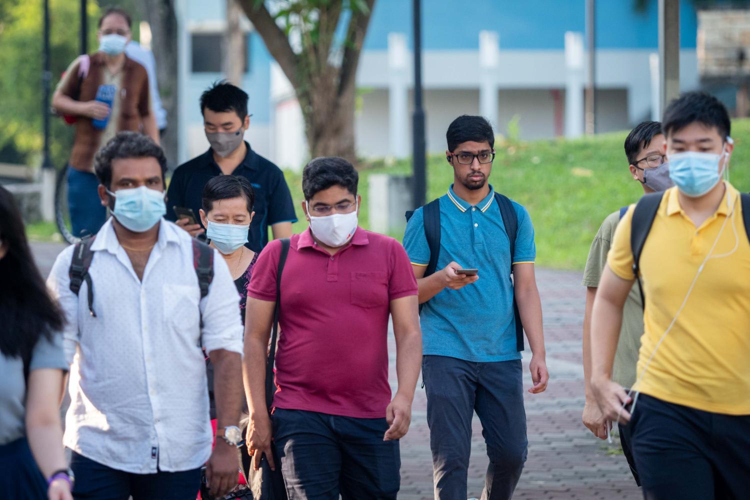 Pedestrians seen in Tampines on March 29, 2022, the first day when people are allowed to choose not to wear masks when outdoors.