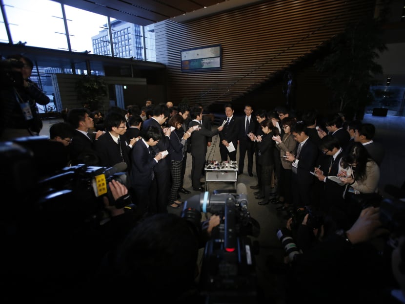 Japan's Prime Minister Shinzo Abe (C) speaks to the media at his official residence in Tokyo today (Feb 1). Islamic State militants released a video yesterday which purported to show the beheading of Japanese journalist Kenji Goto, who the al Qaeda offshoot had been holding hostage.  Photo: Reuters