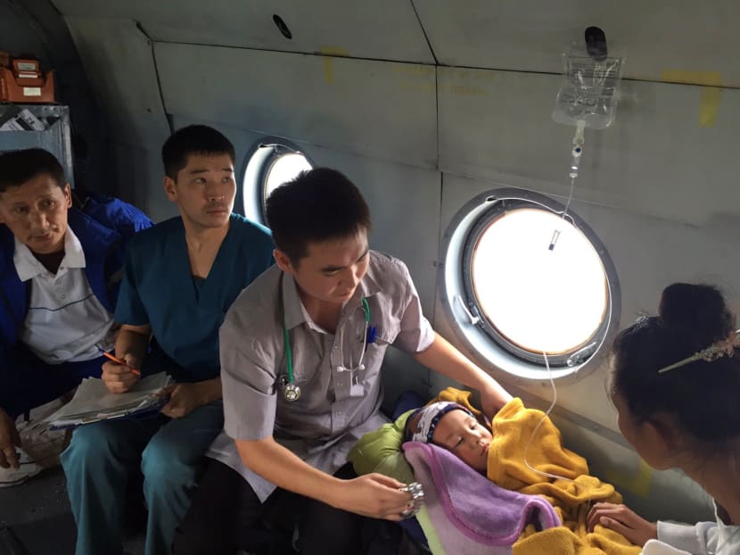 Boy Tserin who went missing in Siberian Taiga lies inside helicopter in Tuva region. Photo: Reuters