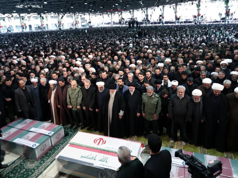 Iran's Supreme Leader Ayatollah Ali Khamenei and Iranian President Hassan Rouhani among those who prayed near the coffin of Iranian Major-General Qassem Soleimani in Tehran, Iran, Jan 6.