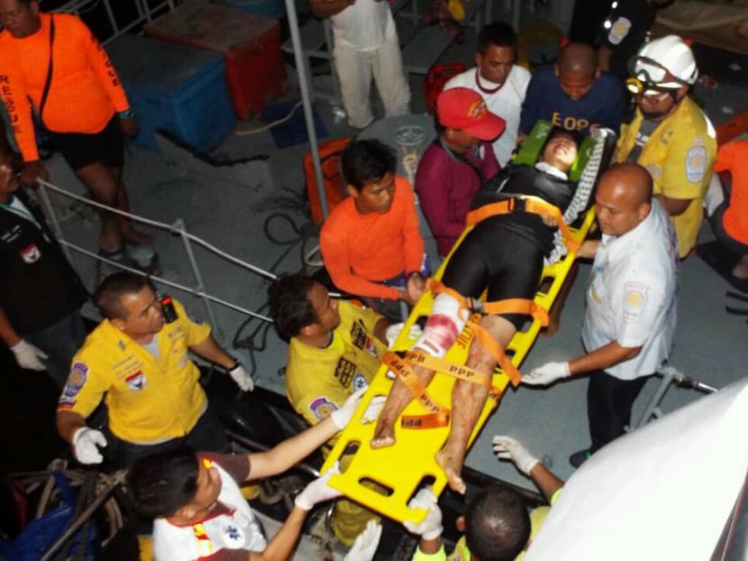 Thai rescue workers  move  a injured tourist on stretcher to hospital  after a fishing boat crashed with a speed boat, carrying tourists from Koh Phi Phi island to a pier in Phuket. Thailand Sunday  Oct 19, 2014. 27 tourists injured and two are  missing. Photo: AP