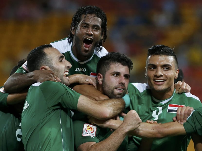 Iraq's Yaser Safa Kasim (centre) is surrounded by team mates as he celebrates his goal during their Asian Cup Group D soccer match against Jordan at the Brisbane Stadium in Brisbane Jan 12, 2015. Photo: Reuters