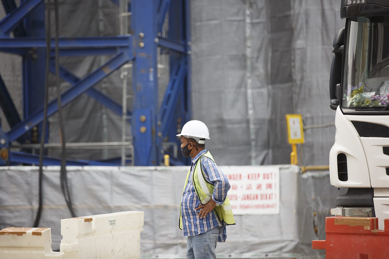 A worker at a construction site along North Bridge Road. A worker at a construction site along North Bridge Road.