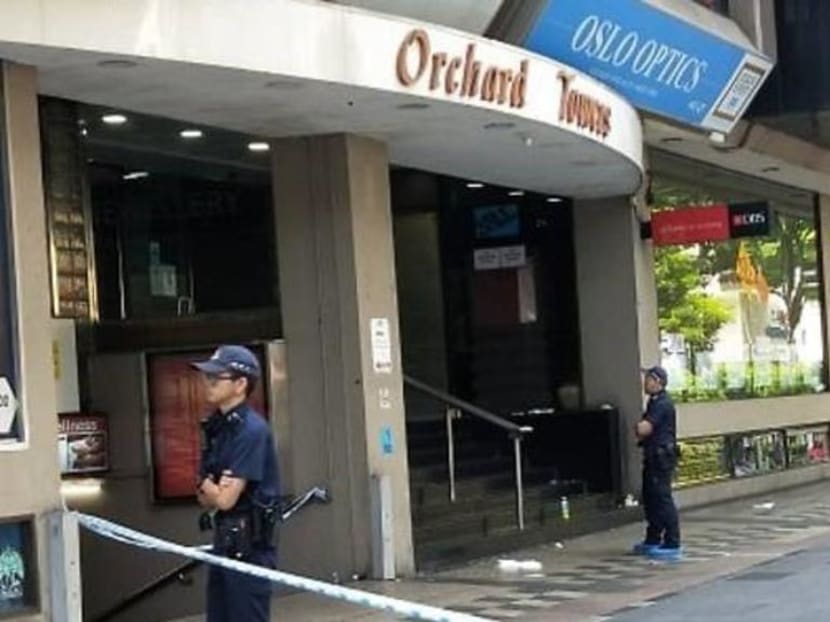 Police officers standing guard at the entrance of Orchard Towers on July 2, 2019, where a man died after being slashed with a knife.