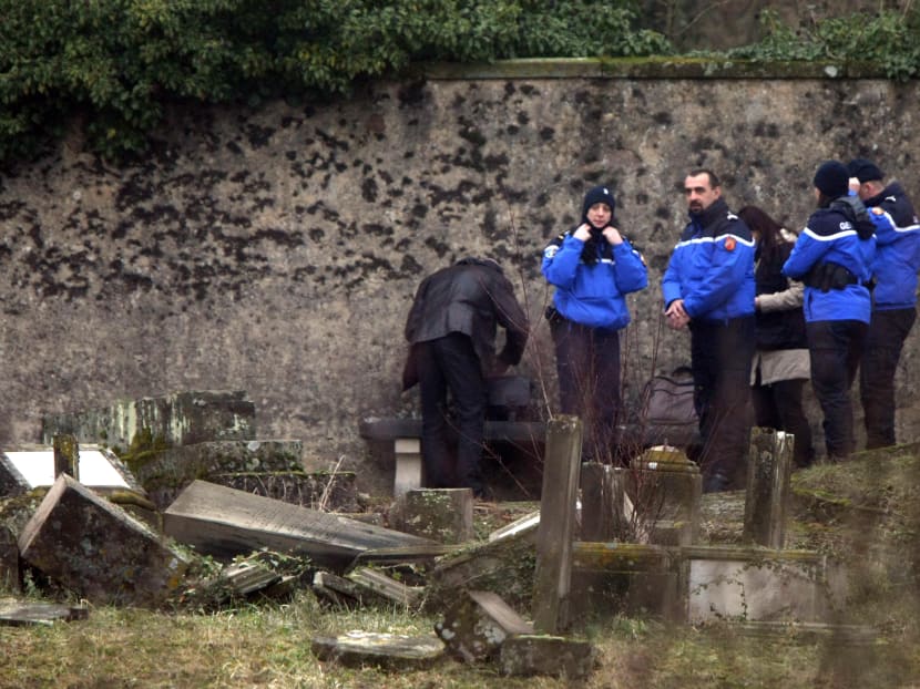 Police officers investigate the site of defaced tombstones at the Jewish cemetery of Sarre-Union, eastern France, Monday, Feb. 16, 2015. Photo: AP