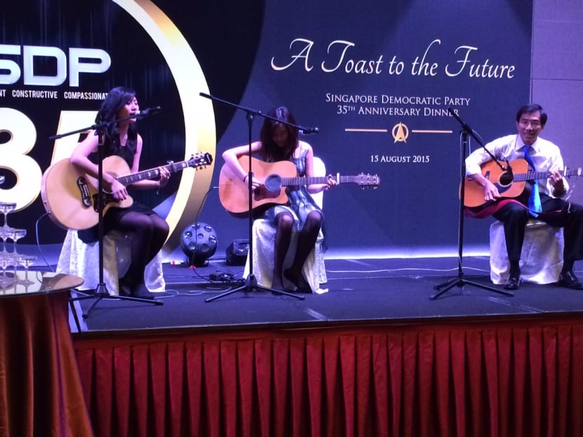 At SDP's 35th anniversary dinner, Dr Chee Soon Juan played the guitar and performed two songs with his daughters. PHOTO: Neo Chai Chin/TODAY