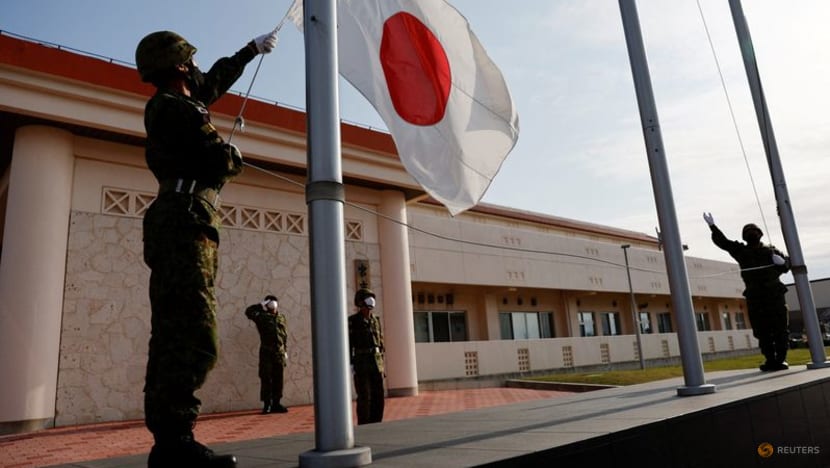 Members of the Japan Ground Self-Defense Force (JGSDF) bring down the Japanese national flag on Apr 20, 2022. (File photo: Reuters/Issei Kato)