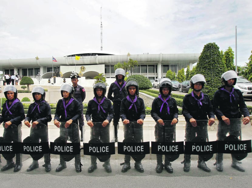 Thai riot policemen standing guard outside Parliament in Bangkok yesterday. Photo: Reuters