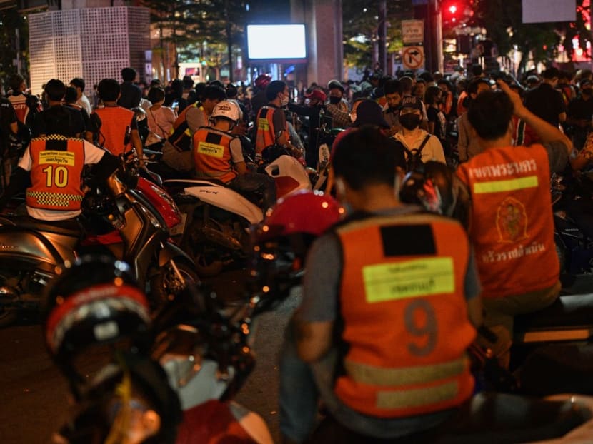 This picture taken on Oct 25, 2020 shows motorcycle taxi riders waiting for pro-democracy protesters to transport at the end of an anti-government rally in Bangkok.