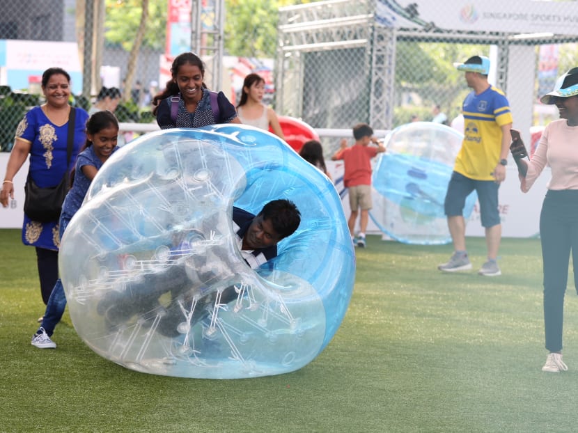 Photo of the day: A father in an inflatable ball being pushed by his family during the Dads’ Day Out carnival at the Singapore Sports Hub's OCBC Square on Sunday (June 17).