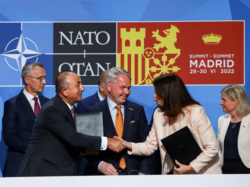 Turkish Foreign Minister Mevlut Cavusoglu shakes hands with Sweden's Foreign Minister Ann Linde after signing a document during the Nato summit in Madrid, Spain, on June 28, 2022.