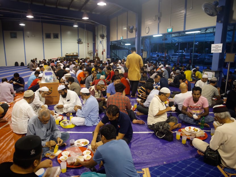 Photo of the day: Congregants gather to break their fast at the temporary prayer space of Masjid Darul Ghufran located along Tampines Avenue 5 on May 17, 2018. Thursday marks the first day of the holy month of Ramadan for Muslims, where they will be fasting every day for a month, refraining from eating, drinking and smoking from sunrise to sunset.
