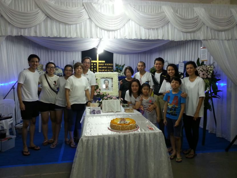 In a bittersweet send-off hours before his body was transported to the Mandai Crematorium, family members brought out the cake and marked a final birthday celebration for Mr Lim at his wake on May 20, 2016. Photo: Lim Keng Swee