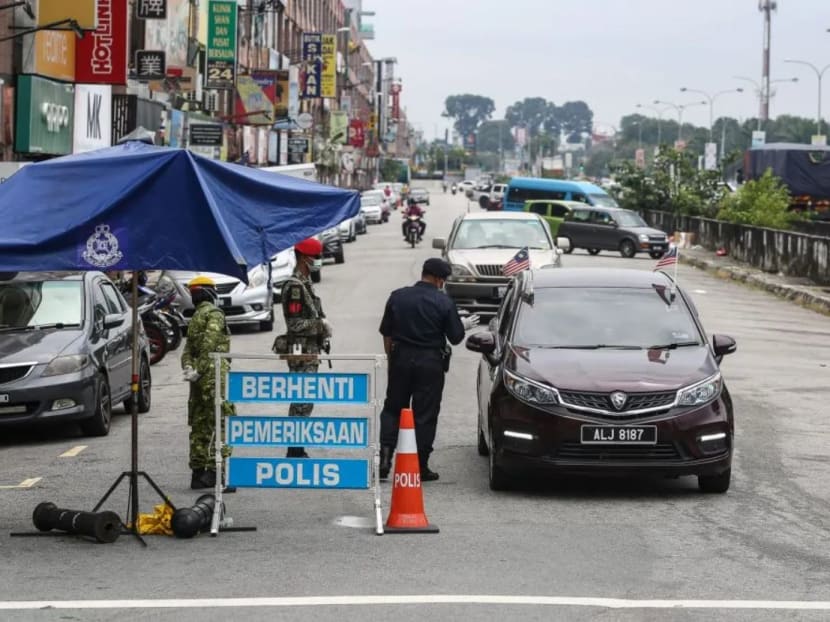 Police and Armed Forces personnel conduct checks during a roadblock on Jalan Batu Unjur in Klang on Oct 11, 2020.