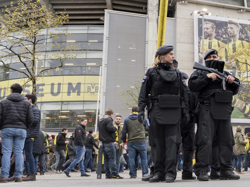 Police officers guarding the stadium in Dortmund, Germany, where Borussia Dortmund took on AS Monaco on Wednesday, after the German team’s bus was attacked the day before. Security authorities are taking a new look at how to protect athletes and spectators. Photo: AP