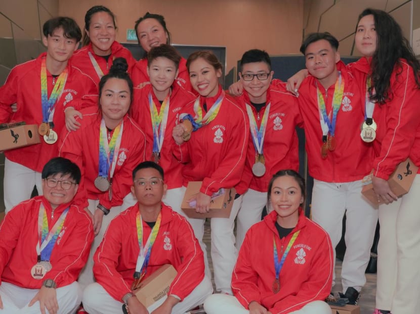 Part of the Singapore powerlifting team who competed at the Southeast Asian Cup, sporting the medals they won. 