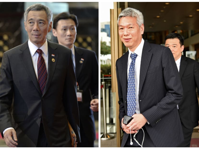 PM Lee Hsien Loong (left) and his brother Lee Hsien Yang. AFP file photos