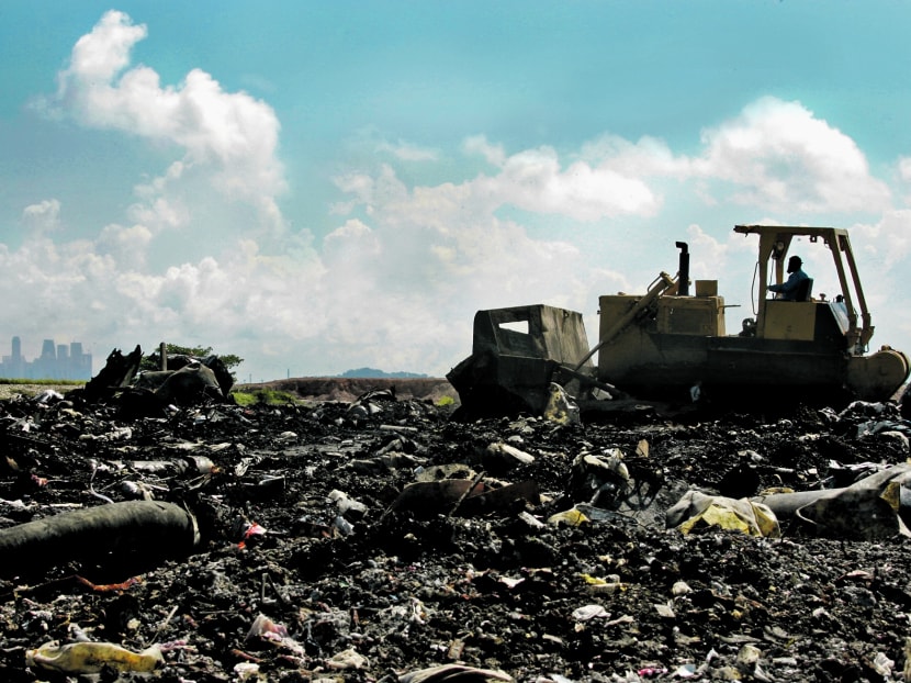 Bulldozers and compactors are used to level and compact the waste at a landfill cell at the Semakau Landfill, which is Singapore's only landfill for waste disposal. TODAY file photo