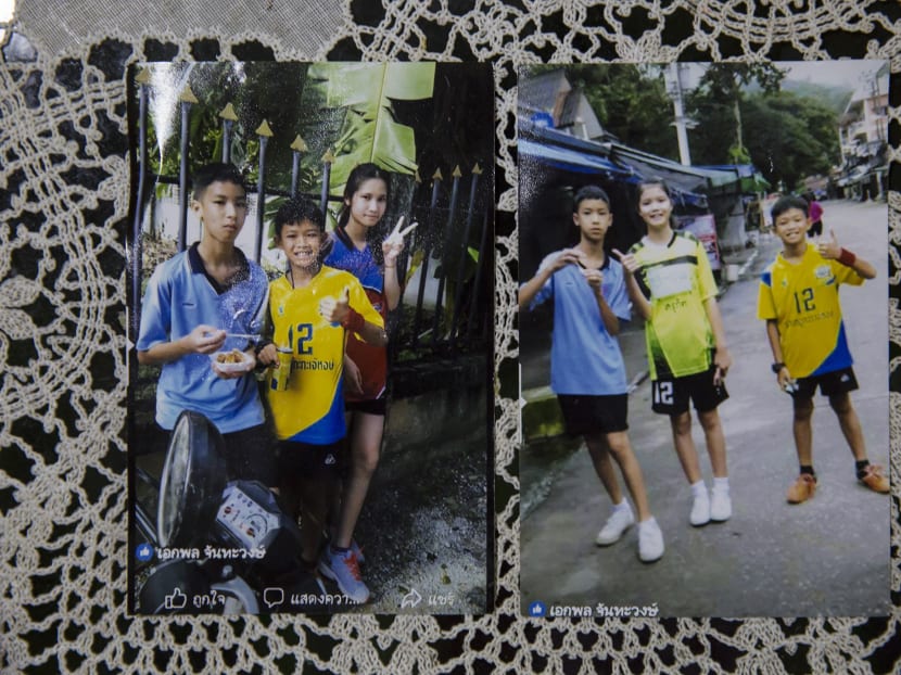 Duangpetch Promthep (in yellow jersey), 13, one of the 12 boys rescued from a cave in northern Thailand,  with his siblings.