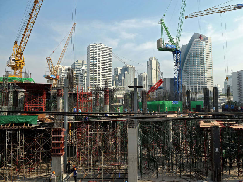 Labourers work at the construction site of a high-rise building in Bangkok, Thailand. Thailand's tourism and sports minister is on an economic mission to draw high-net worth individuals to the country not only to holiday, but also to live, invest and for retirement. Photo: AFP