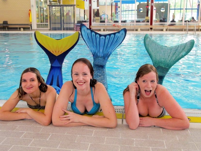 A picture taken on Oct 4, 2016 shows three women dressed up as mermaids posing by a pool at a mermaid training school at Dijnselburg swimming pool in Zeist. Photo: AFP